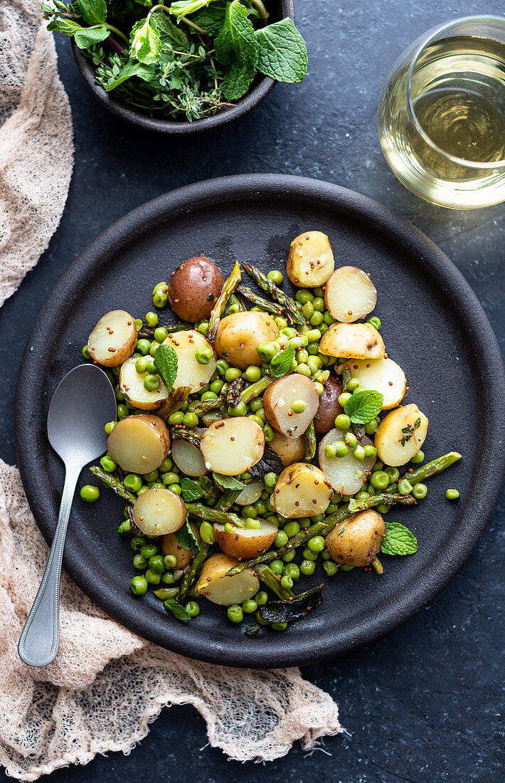 Rustic potato salad on black ceramic plate