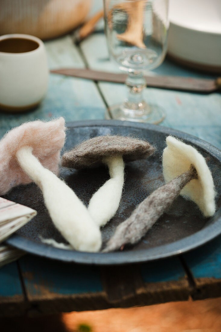 Felted mushrooms on plate on table