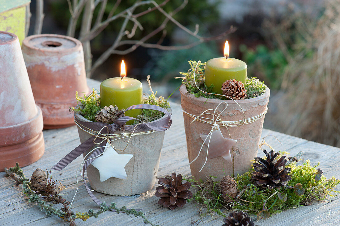 Green candles in terracotta pots