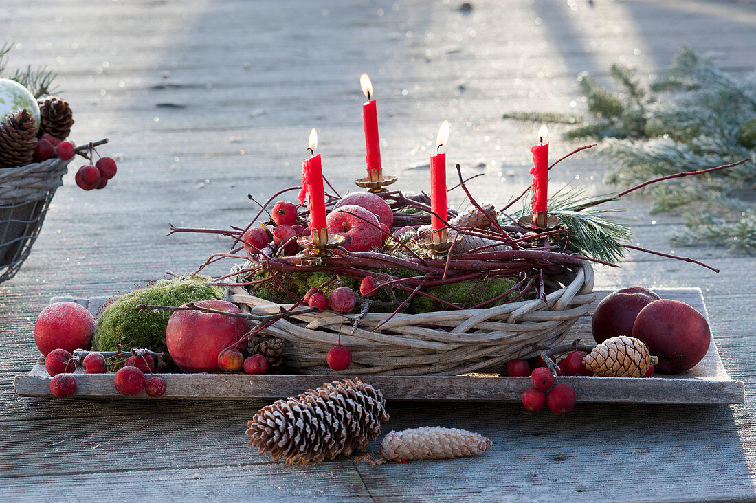 Small Advent wreath with branches in basket bowl