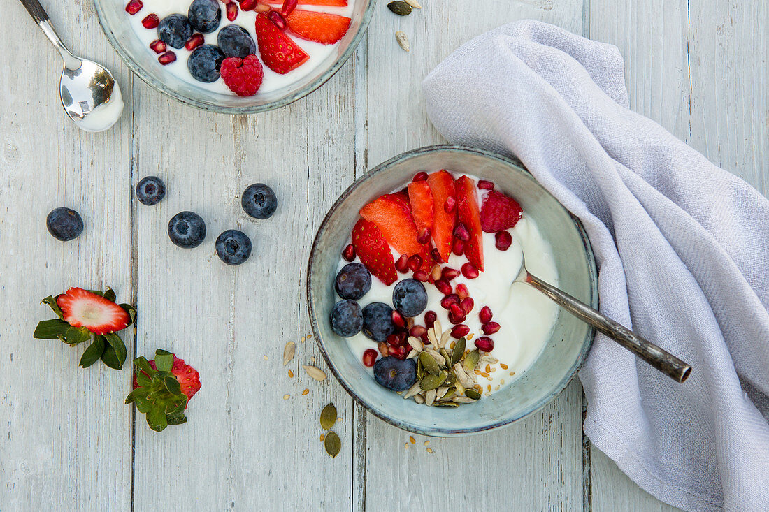 Yoghurt with berries, pomegranate and seeds