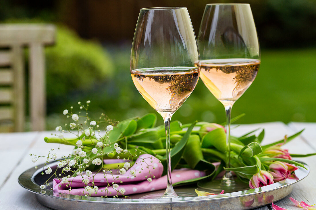 Glasses of Rose Sparkling wine in outside garden setting