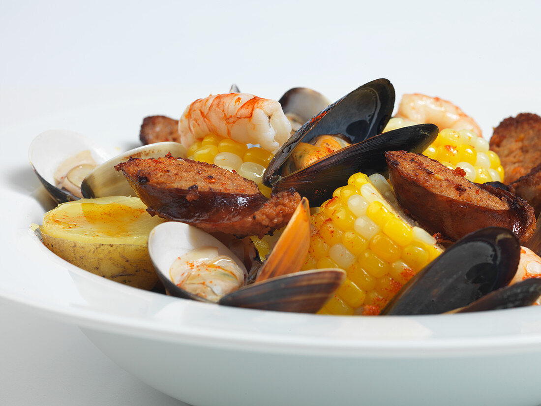 Seafood stew with sausage, potatoes and corn