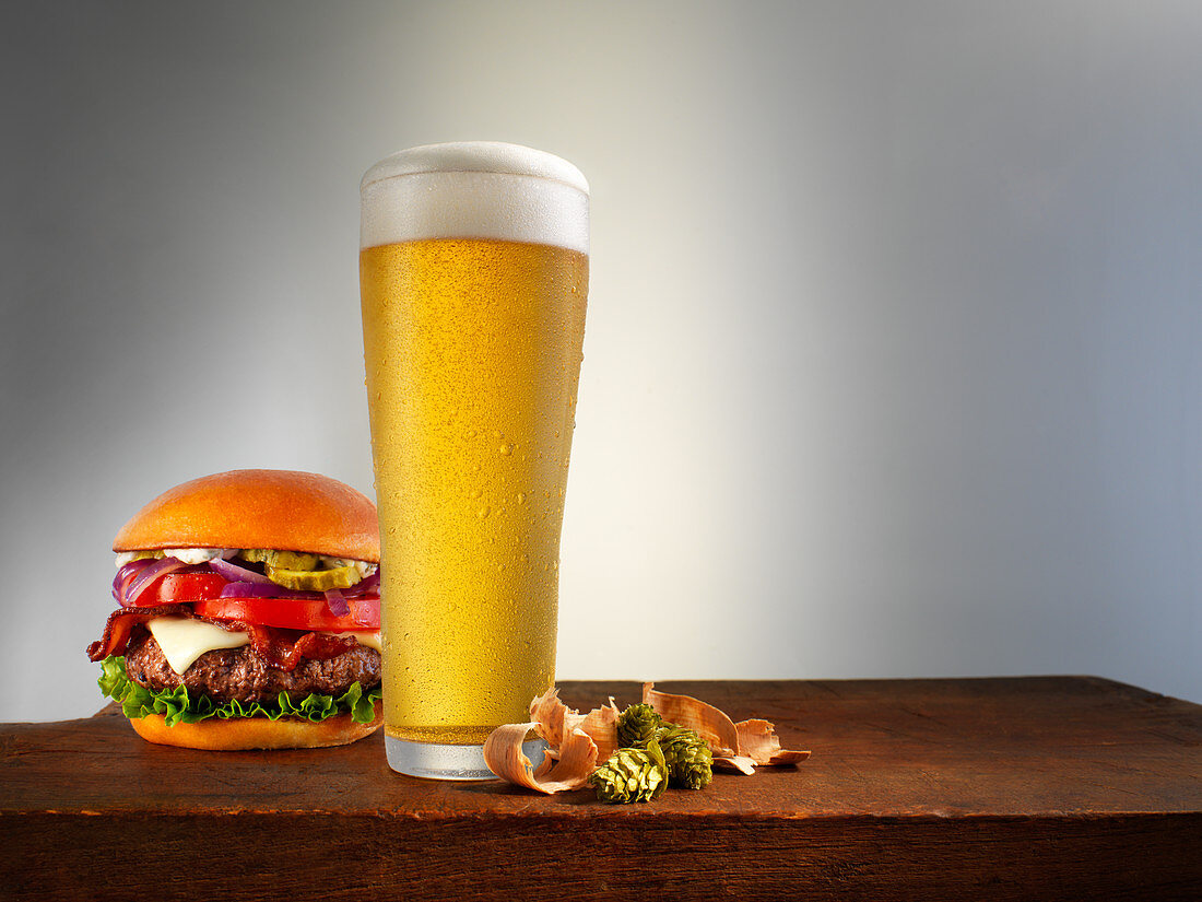 A cheeseburger and a glass of beer