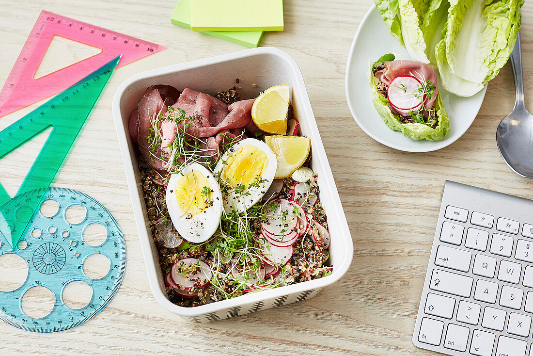 A quinoa bowl with roast beef, egg and cress for an office lunch