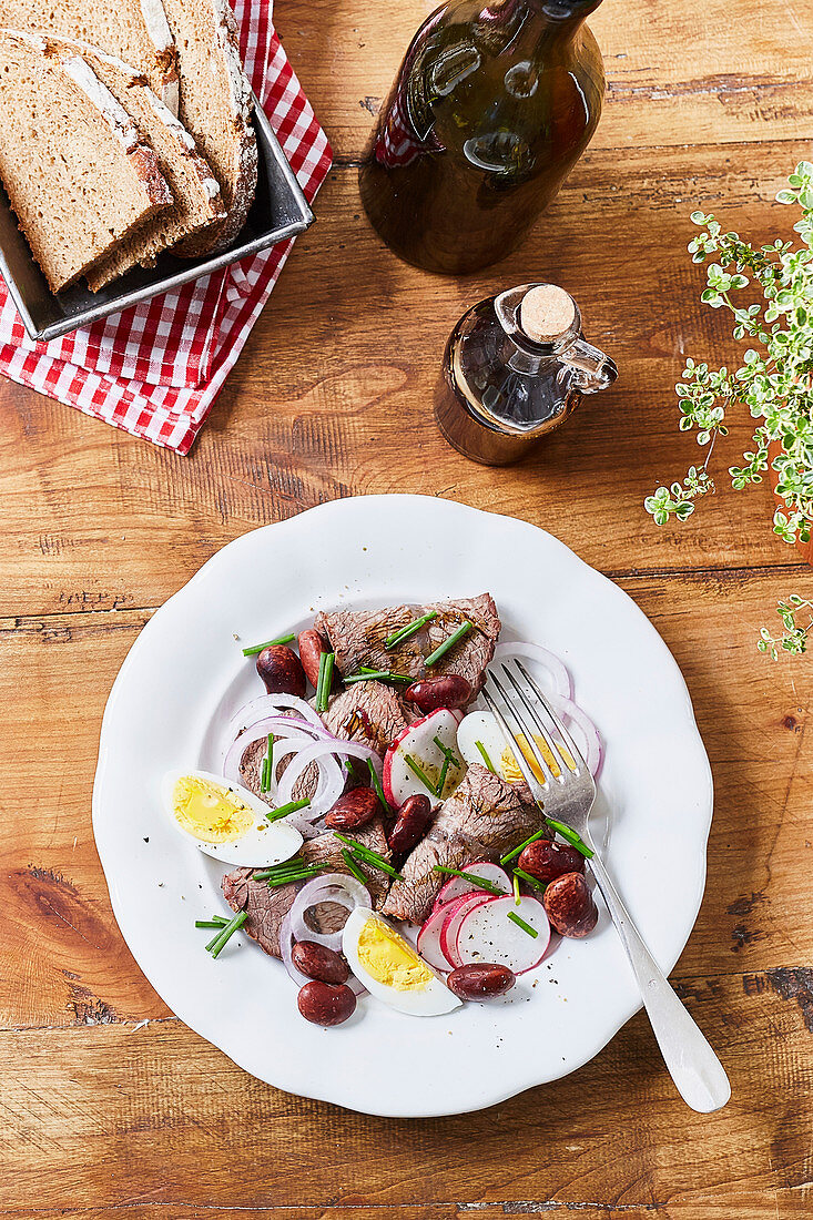 Beef salad with radishes, beans and egg