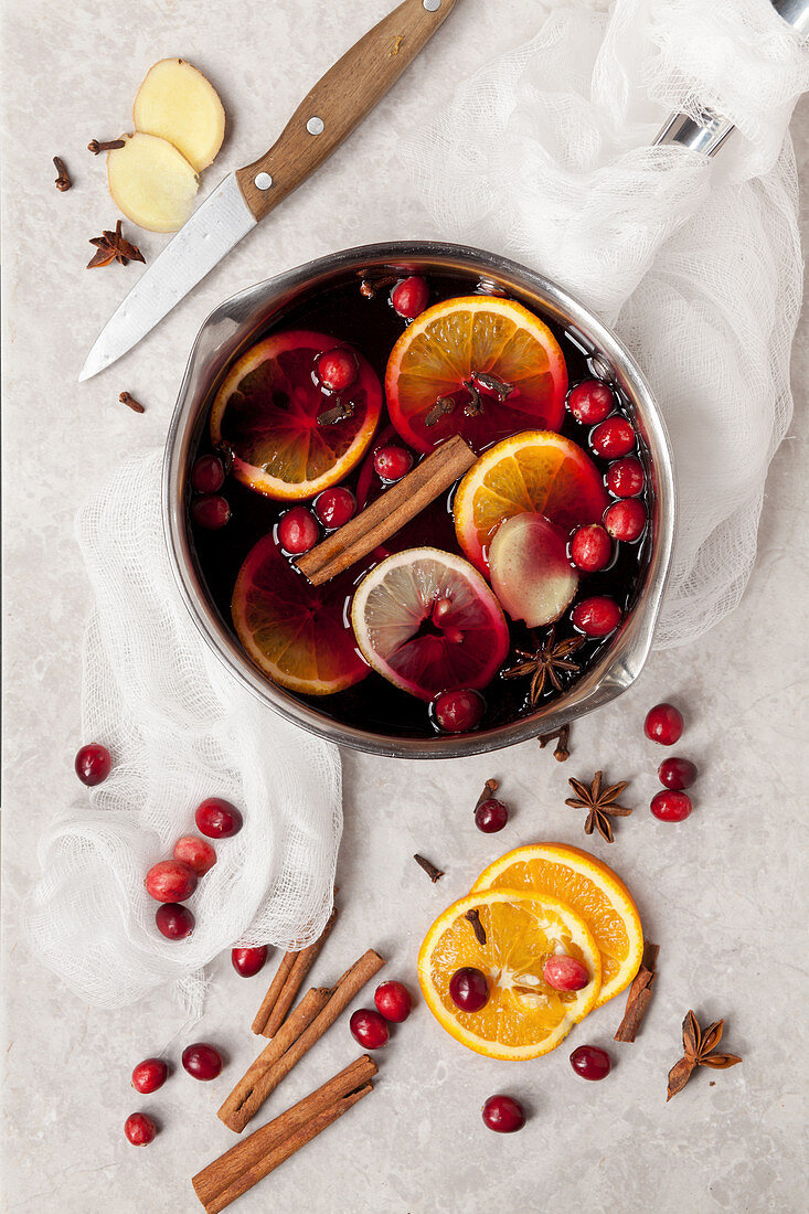 Alkoholfreier Glühwein mit Cranberries, Orangenscheiben und Gewürzen