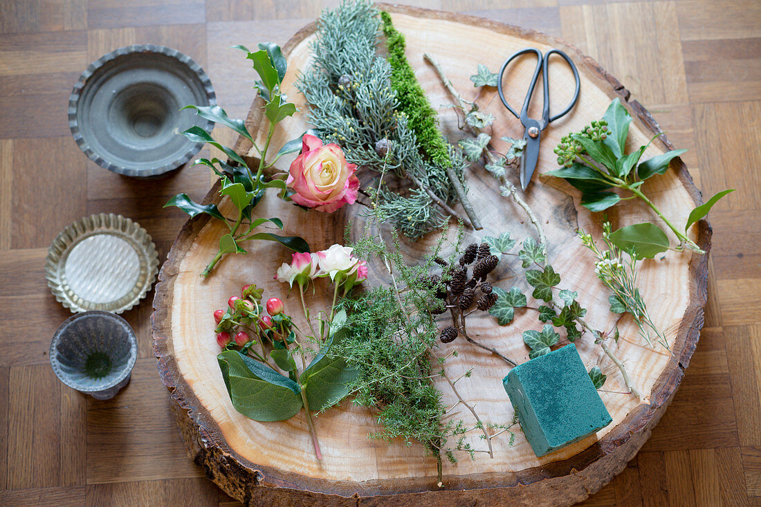 Florists materials on slice of tree trunk