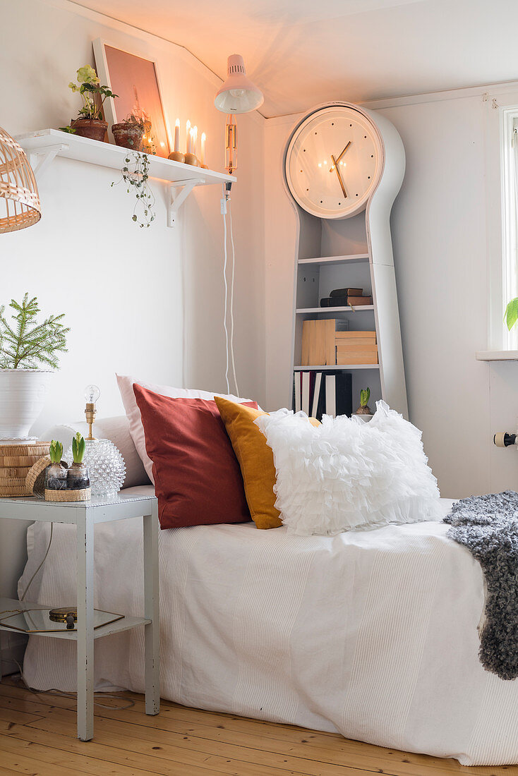 Scatter cushions and longcase clock in guest room