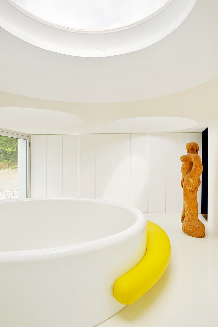 Large round bathtub in minimalist bathroom