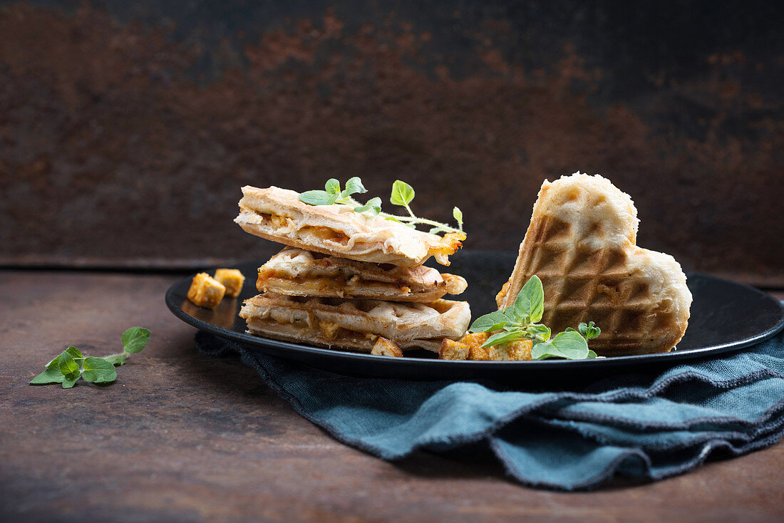 Pizza waffles filled with tomato sauce, almond cheese and tofu (vegan)