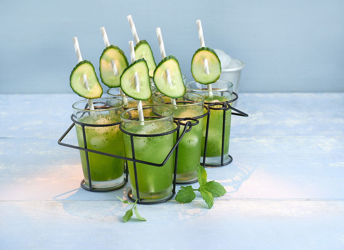 Cucumber and lime smoothies with mint in glasses in a cup holder