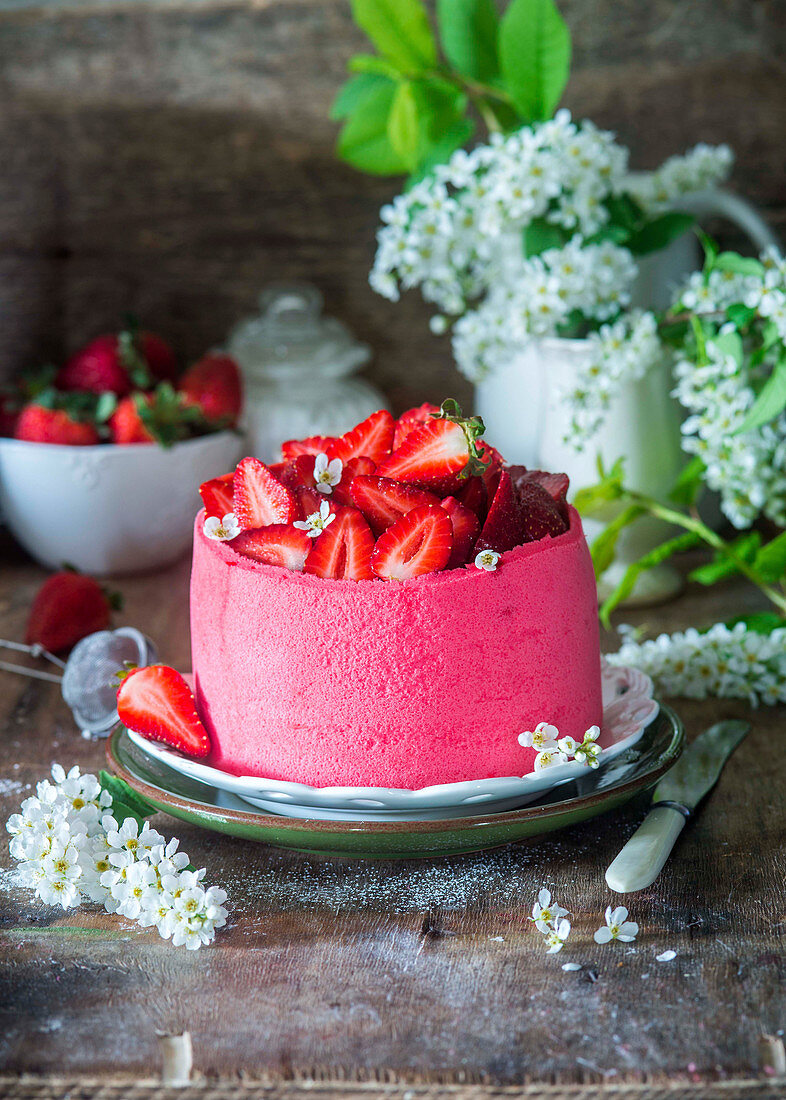 Strawberry profitrole cake with cream cheese mousse and strawberry cream inside profitroles