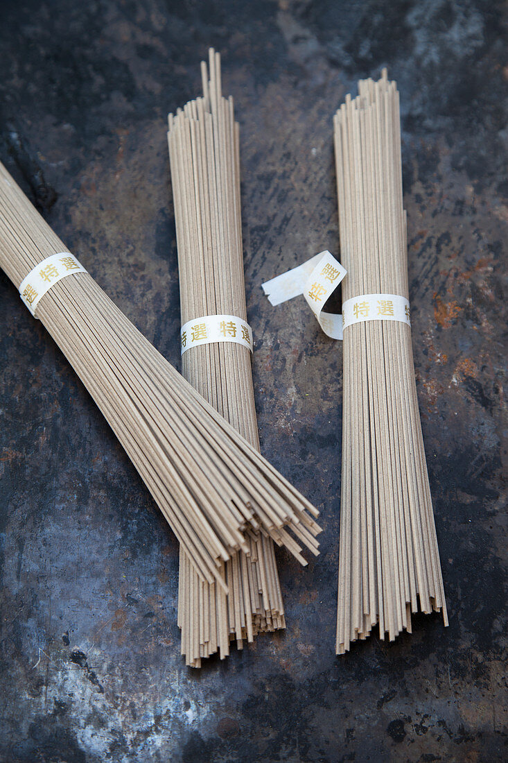 Three bundles of soba noodles made from buckwheat