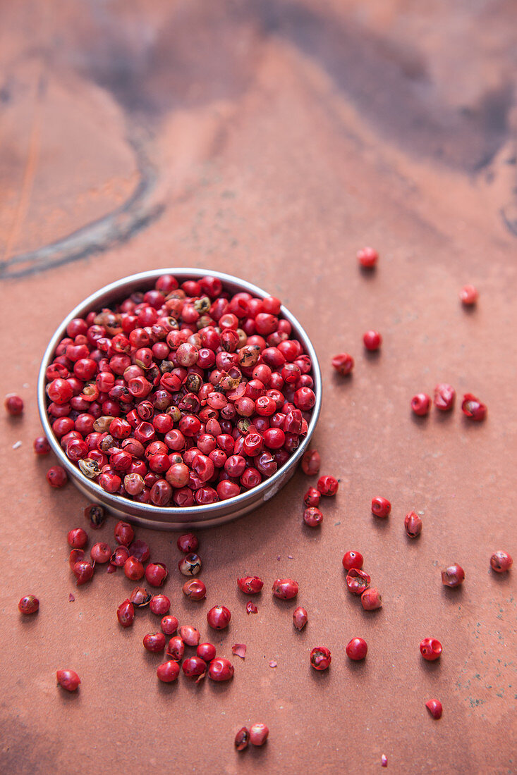 Red peppercorns in a small bowl