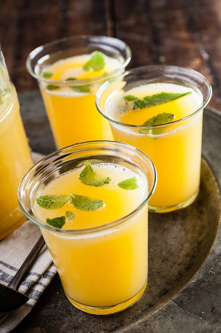 Orange juice with mint in three glasses