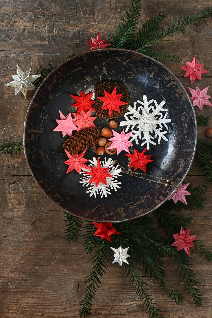 Christmas stars and snowflakes hand-made from pink, red and white paper