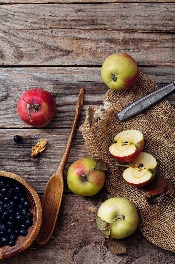 Blueberries, apples on rustic background