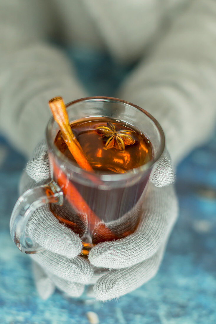 A woman holding a glass of hot punch