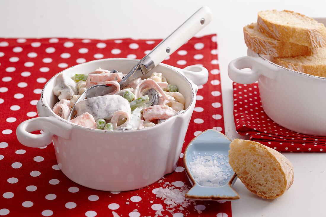 Spicy soused herring and pasta salad with slices of baguette
