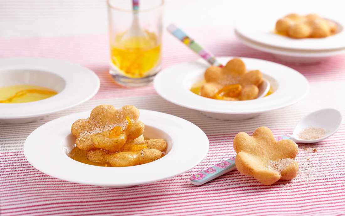 Deep-fried, sweet pastry flowers with orange syrup