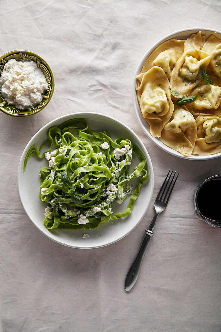 Traditional italian ravioli with ricotta cheese and spinach tagliatelle served with a glass of red wine