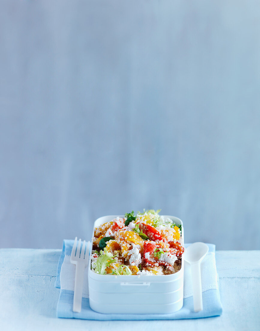Couscous salad with peppers and feta in a lunch box