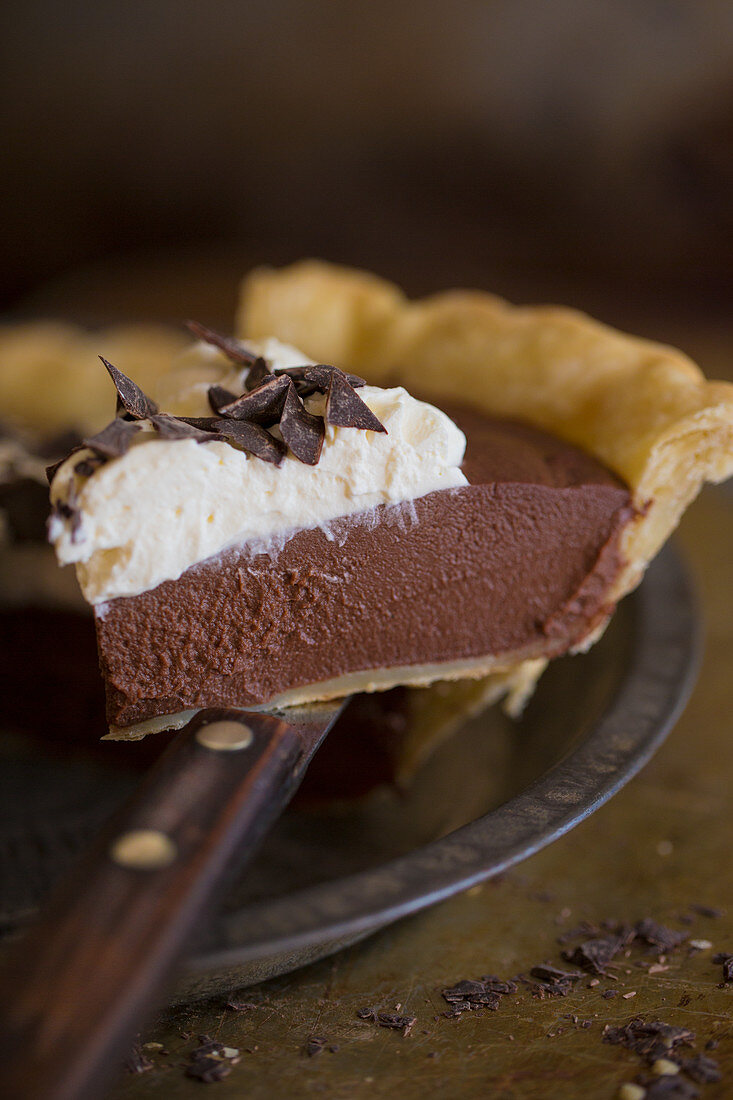 A piece of chocolate pie with cream