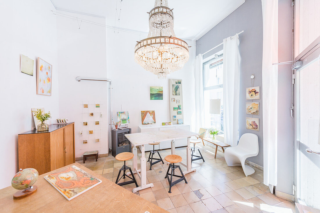 A table with old industrial stools and photo art on the wall