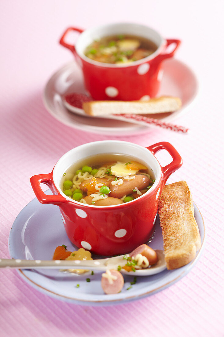 Alphabet soup with mini sausages and toast