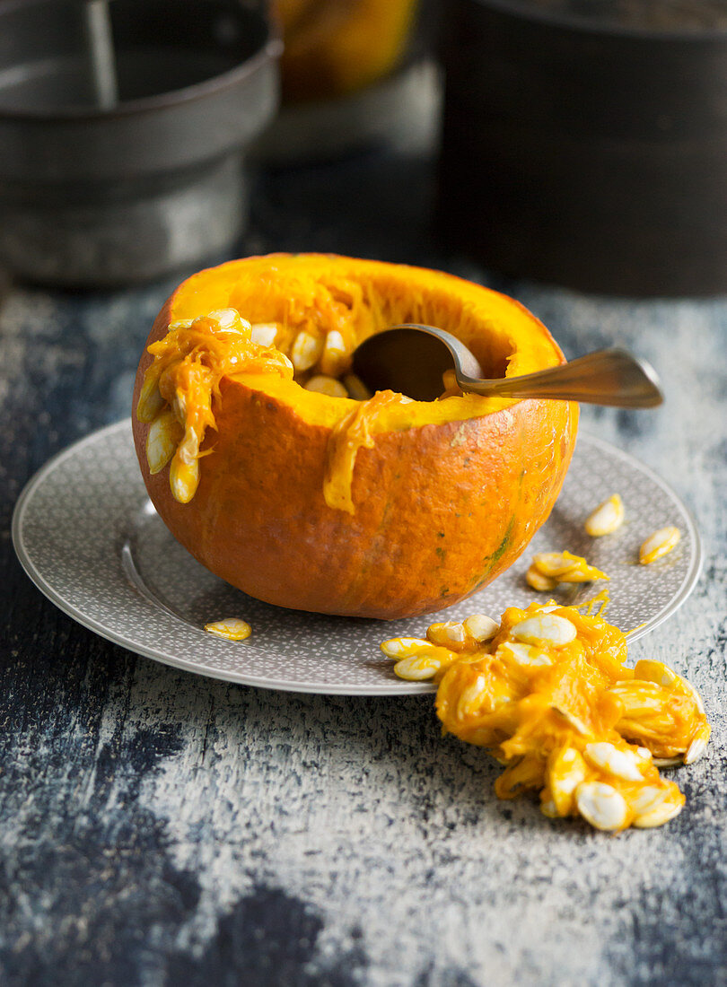 Hokkaido pumpkin being hollowed out