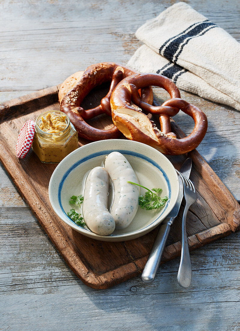 White sausages with pretzels and sweet mustard