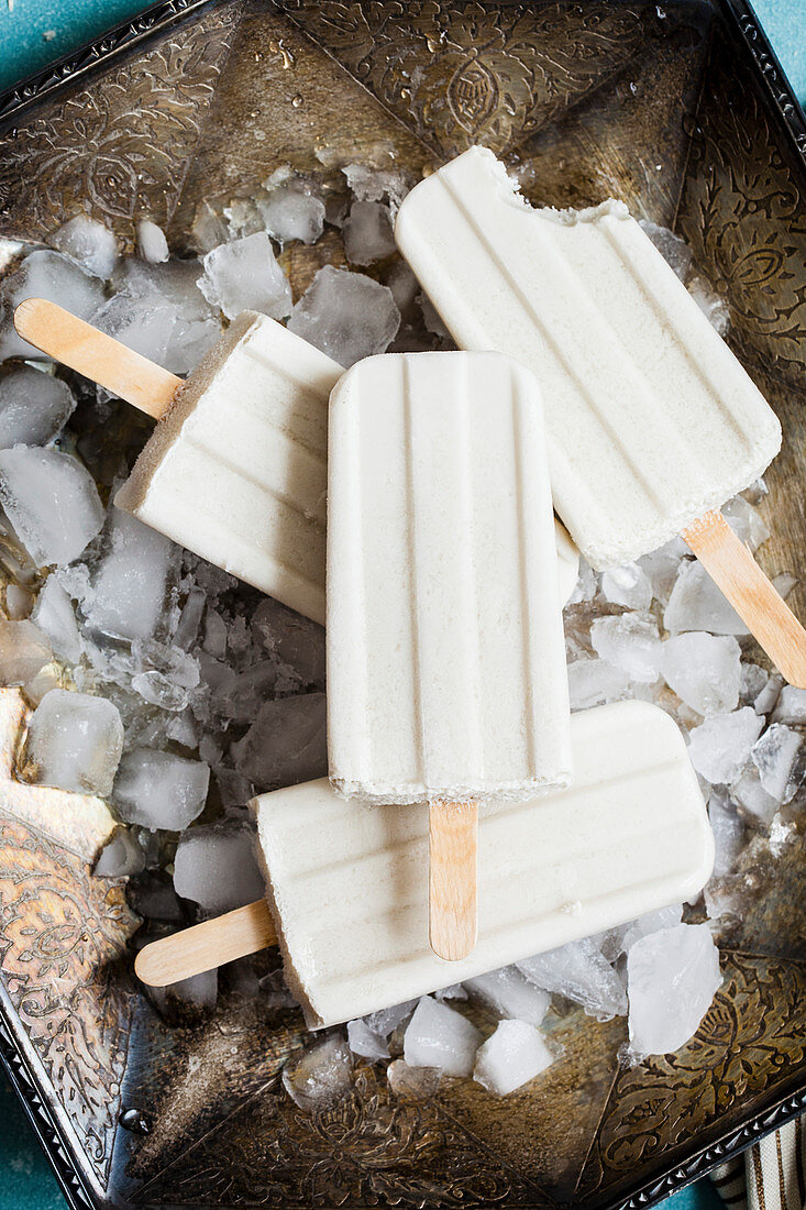 White popsicles on metal tray with ice