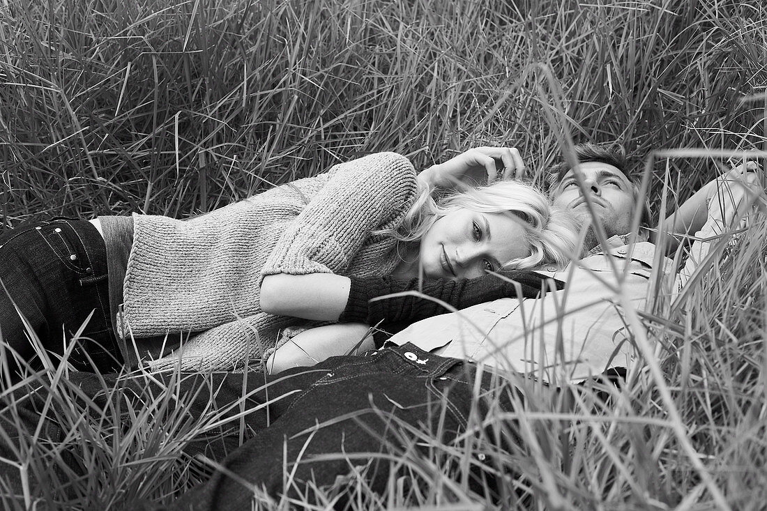 A couple lying in the grass (black-and-white shot)