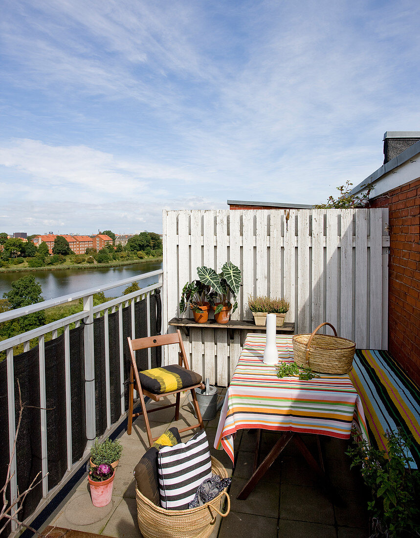 Striped patterns on table, bench and cushions on balcony