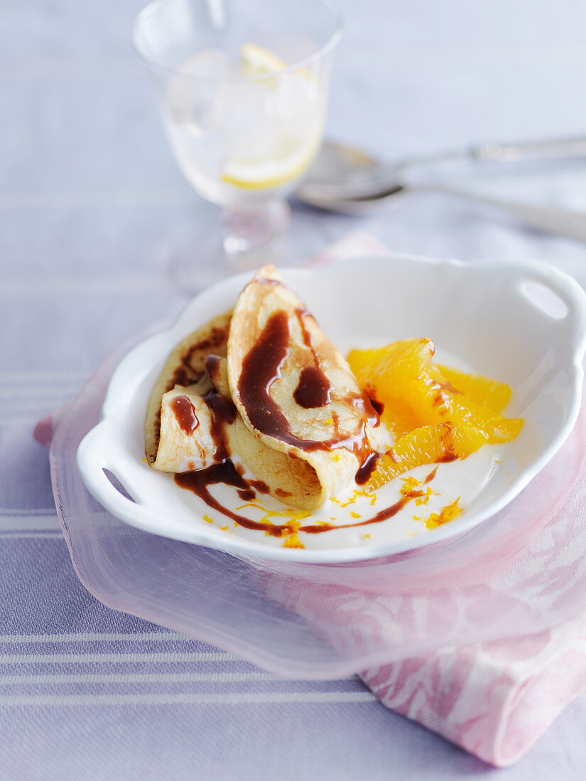 Pancakes with oranges and chocolate sauce