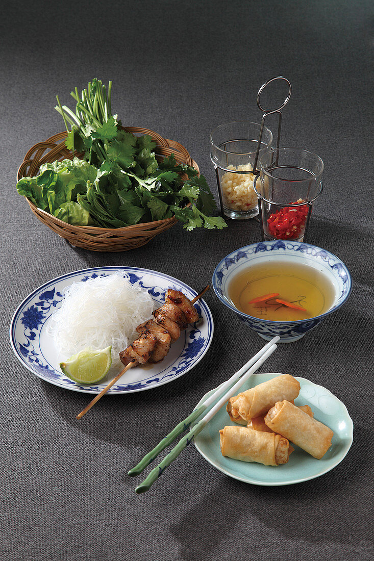 Bun cha (spring rolls, rice noodles with meat skewer and herbs, Vietnam)