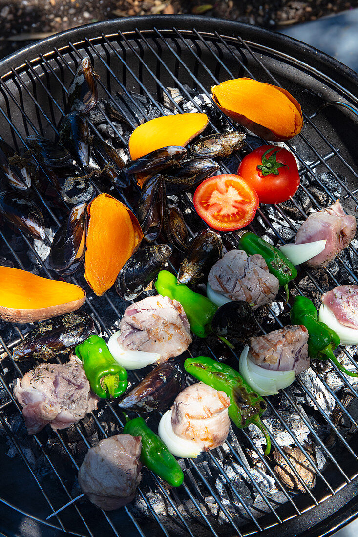 Pork kebap and mussels on grill