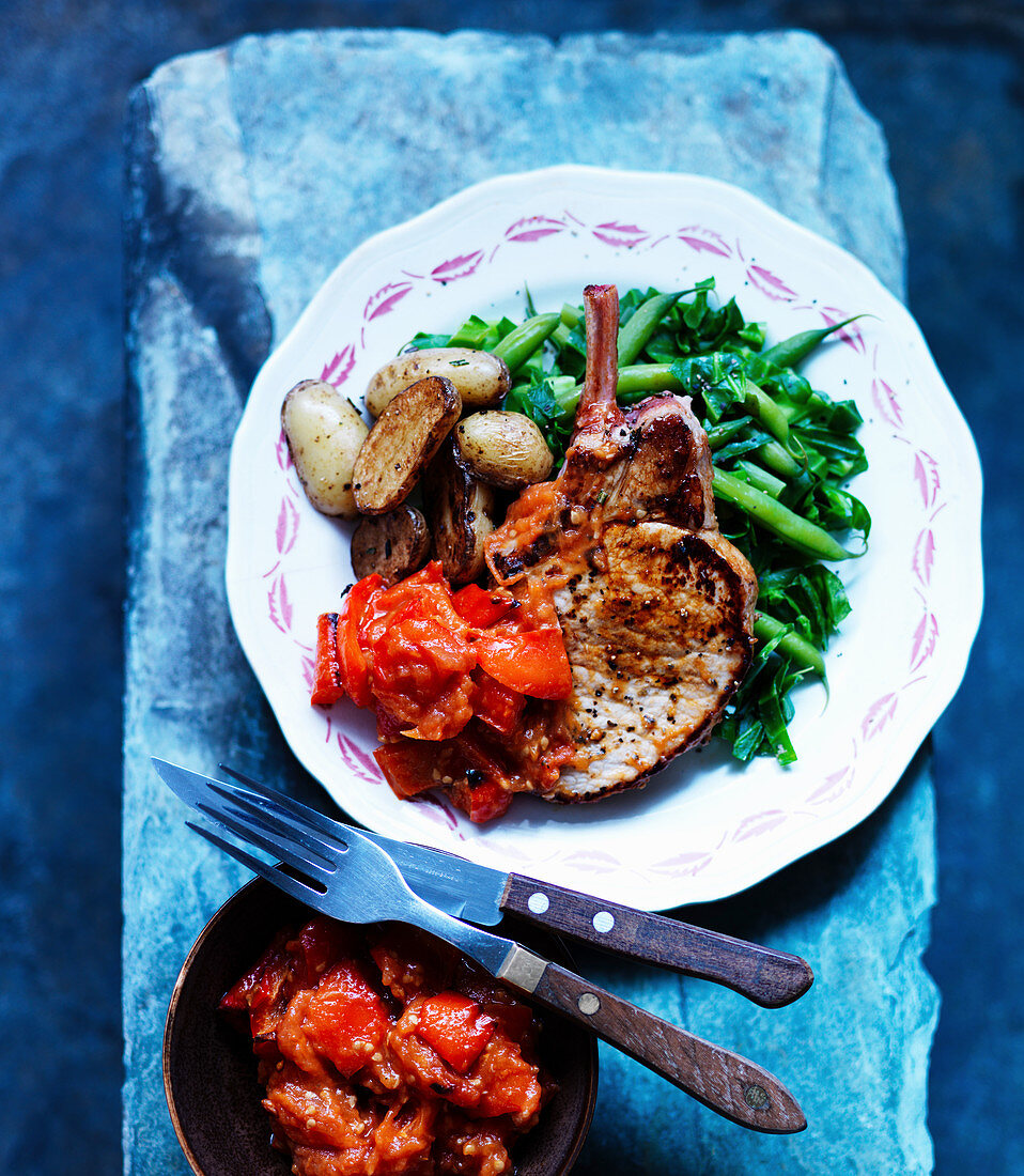 Pork chops with beans, cabbage, potatoes and tomatoes