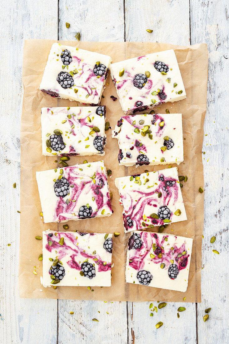 Ice cream parfait, blackberries and pistachios on baking paper