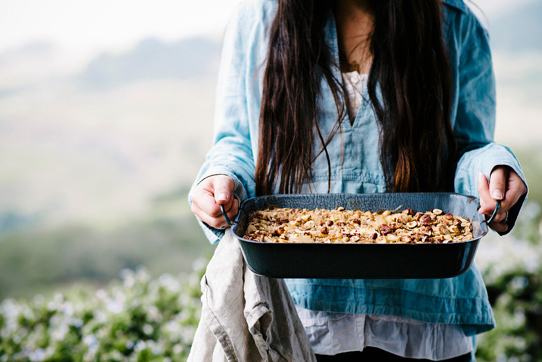Woman holding baked granola cereal on a farm