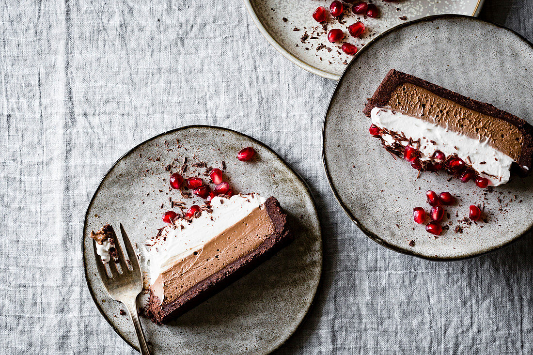 Chocolate tart with cream and pomegranate seeds (vegan)