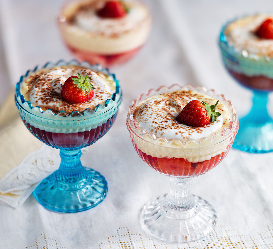 Strawberry trifles with cream, vanilla pudding, jelly, yogurt and cinnamon