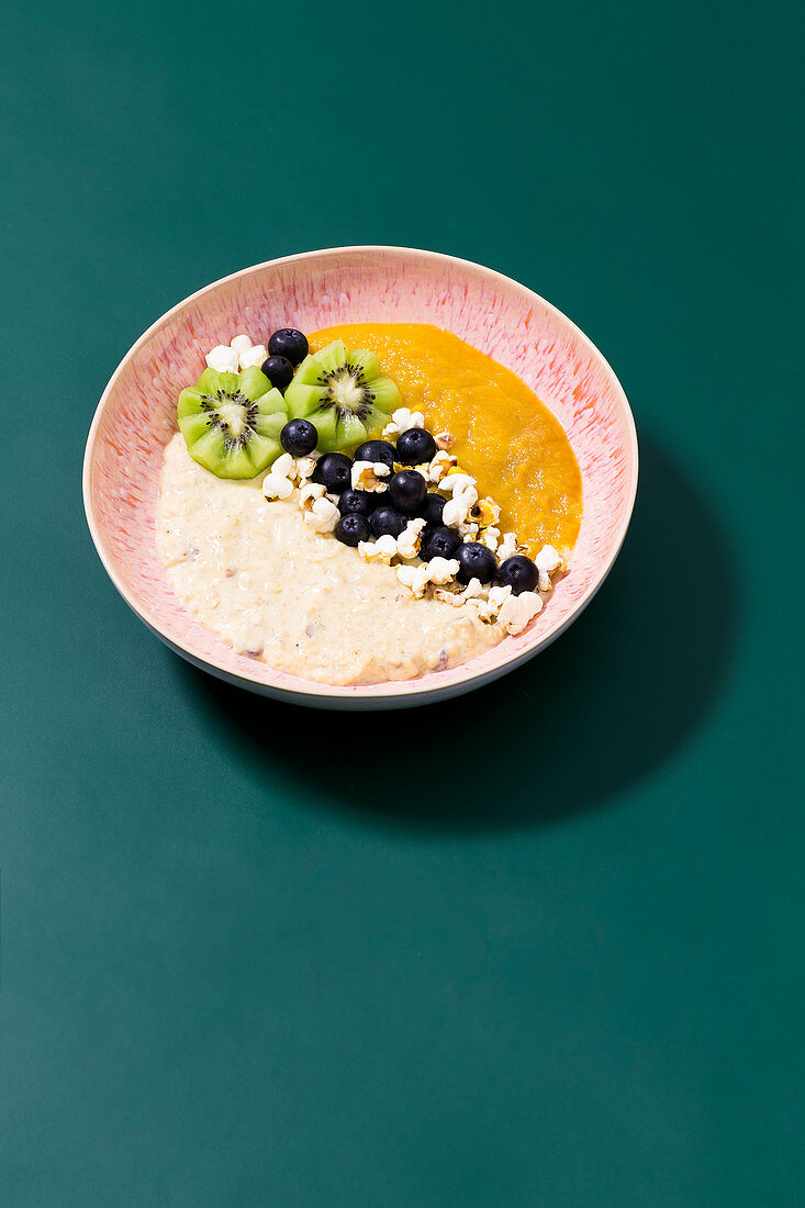 Popcorn mango bowl with blueberries, kiwi and barley