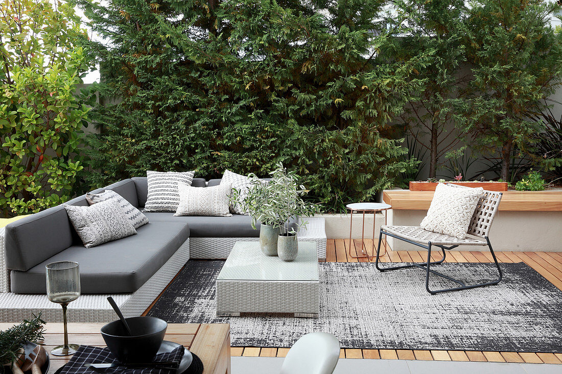 Grey outdoor furniture on elegant wooden terrace