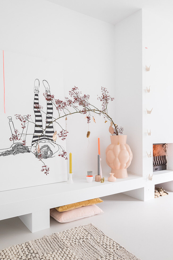 Branch of berries in large vase on masonry shelf