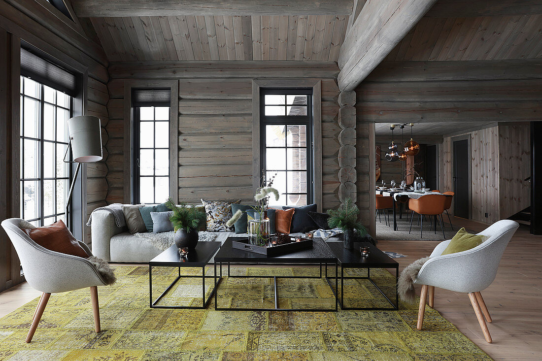 Living room with open doorway leading into dining room in log cabin