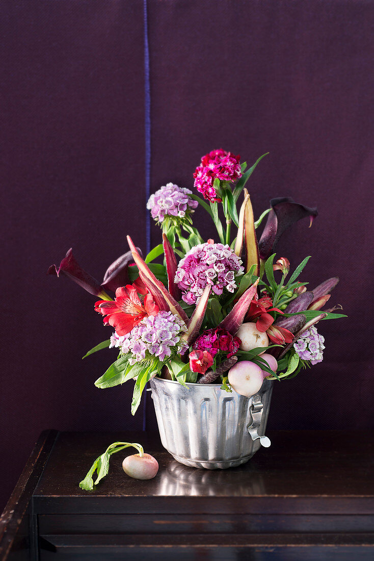 Autumnal bouquet of vegetables and flowers in cake tin