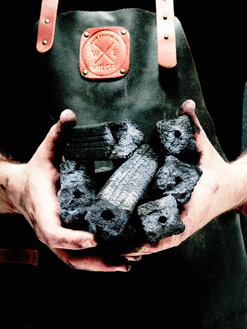 A man holding charcoal