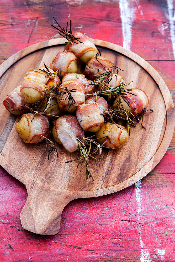 Grilled potatoes in bacon with rosemary and chilli garlic oil